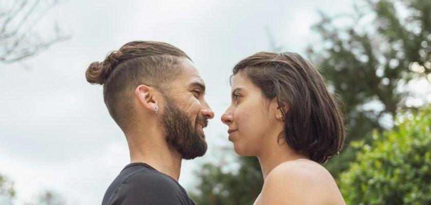 A loving couple facing each other in the open air