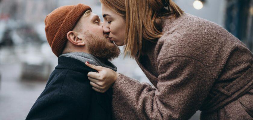 Adult loving couple kissing on a street