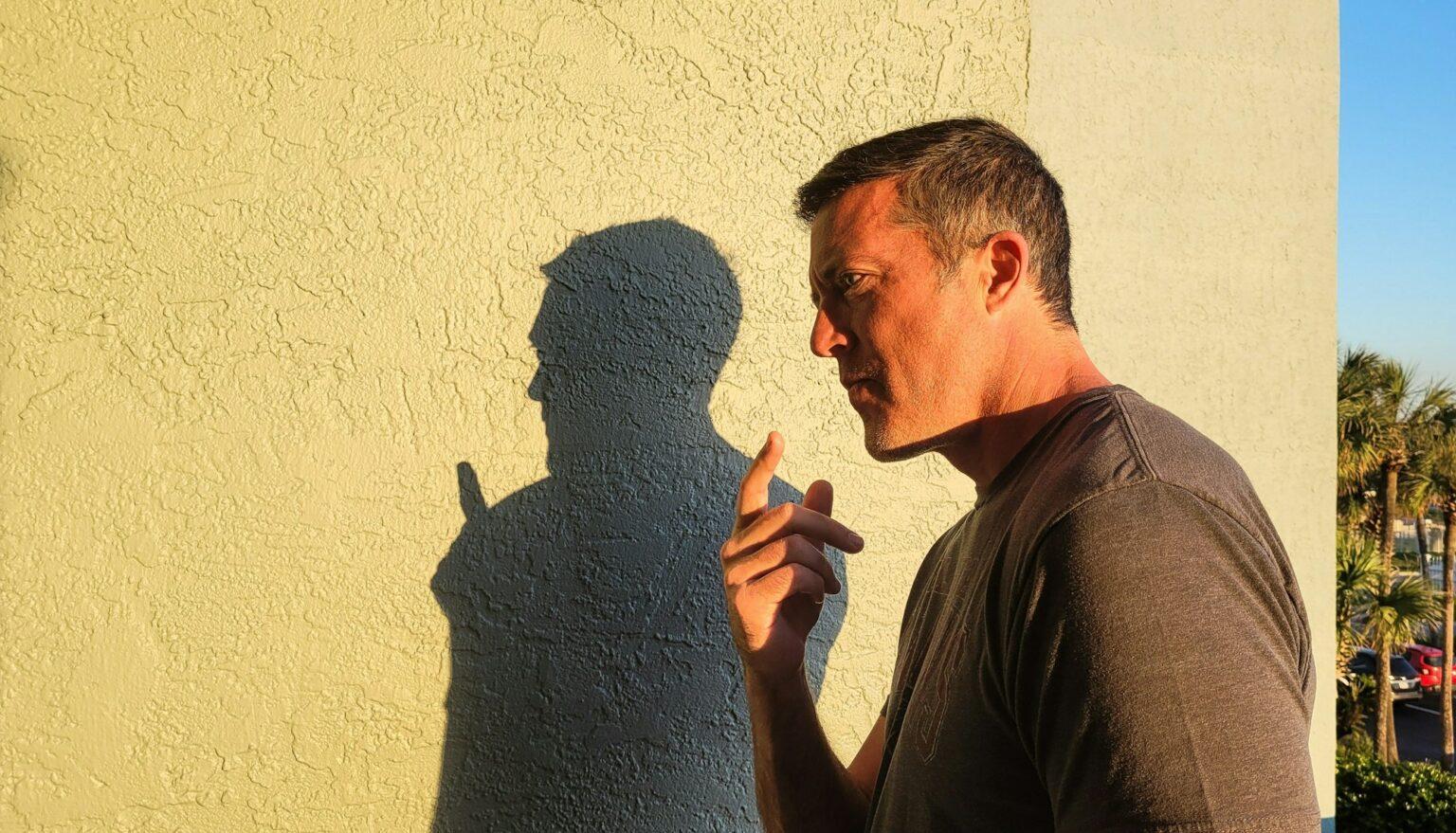 Generation X young man meets his shadow self in mental health situations in candid moments.