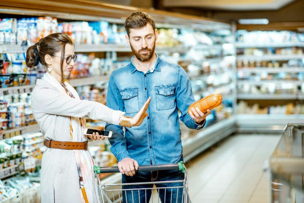 Couple buying sausages in the supermarket