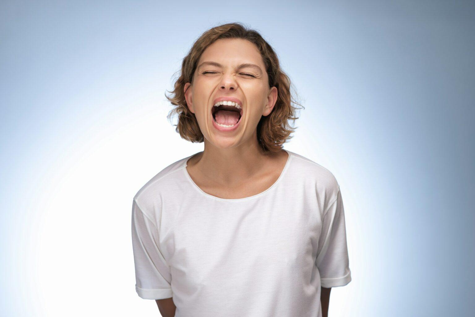 Screaming, Hate, Rage Emotional Portrait of Angry Woman in Studio