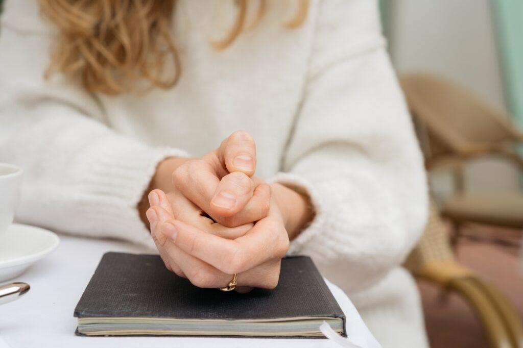 Cropped shot of a woman sitting in cafe and feeling anxious