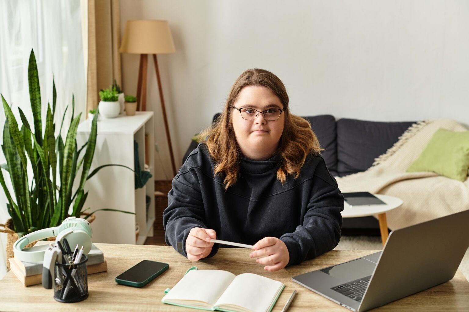 Confident young woman with Down syndrome enjoys her cozy home workspace