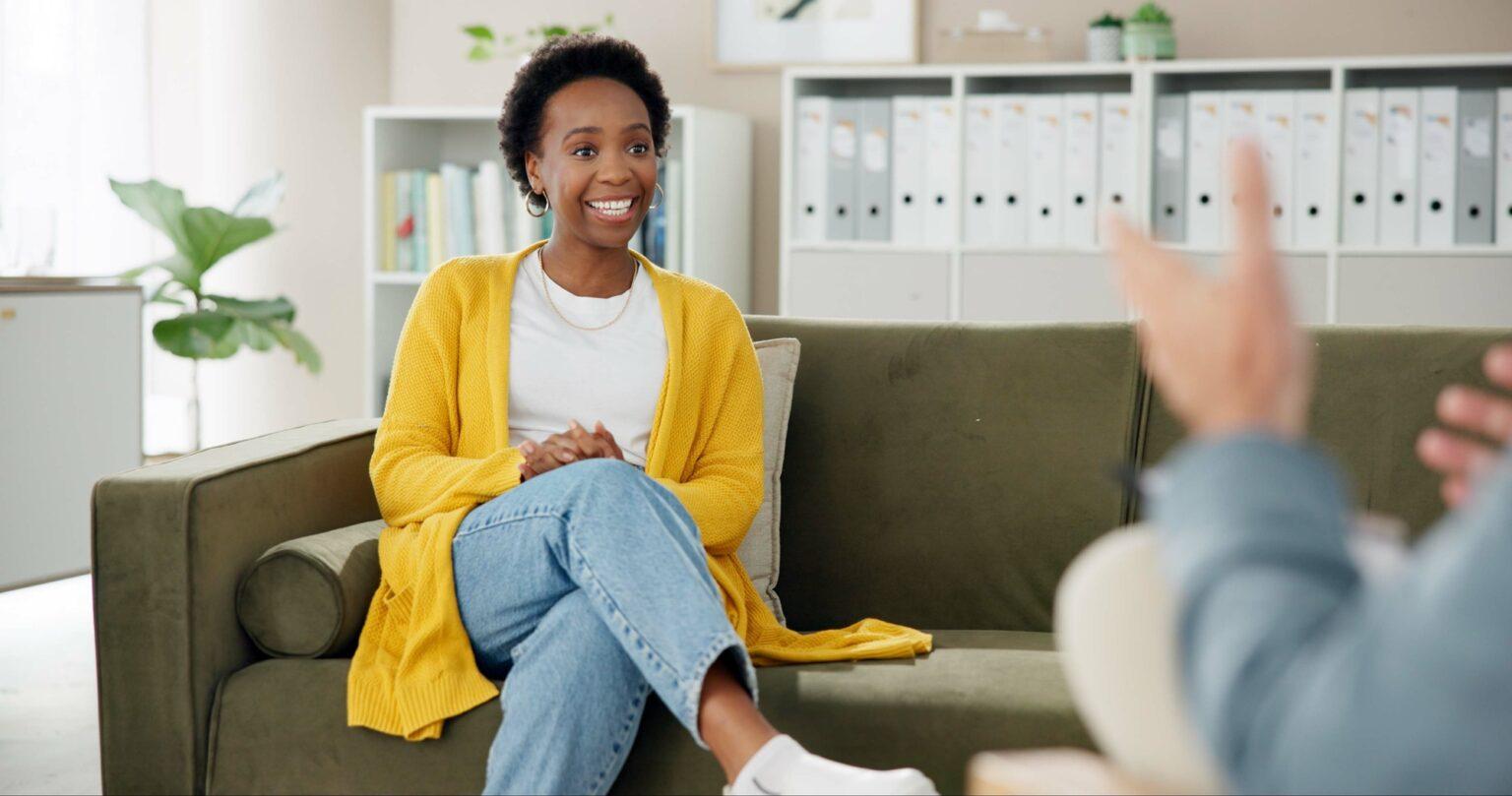 Psychology, therapist and woman on couch with smile, counseling and hope for anxiety management. Me