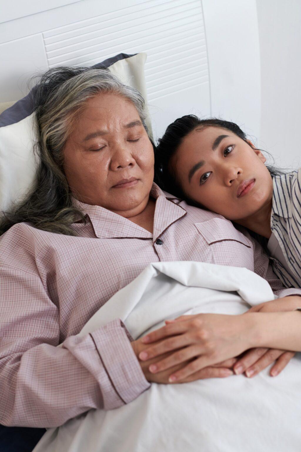 Woman Leaning Head on Shoulder of Sick Mother
