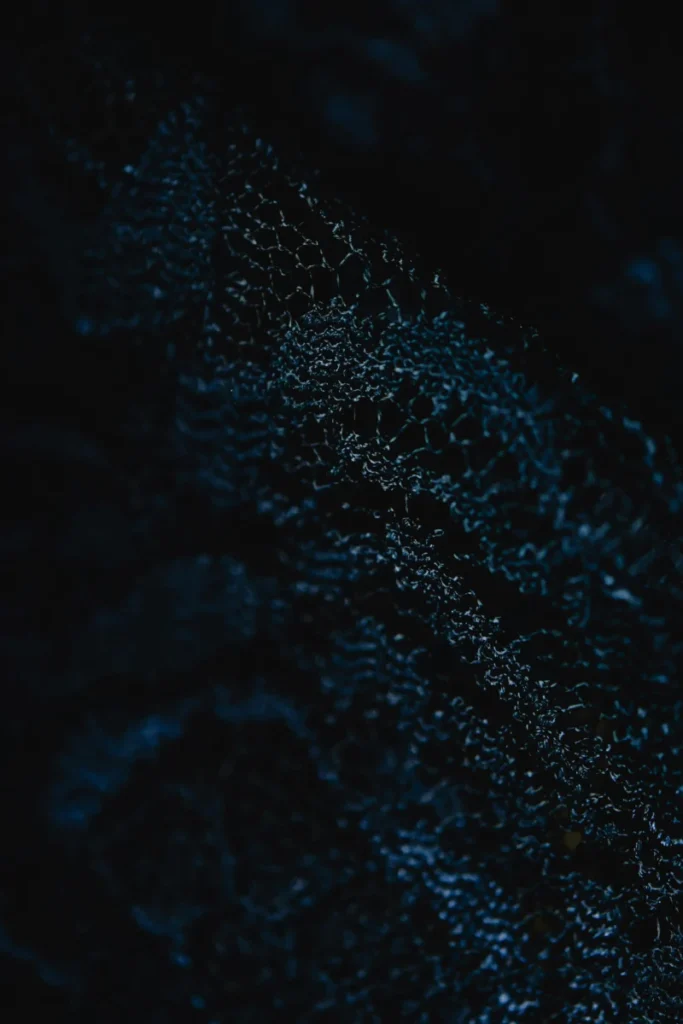 Close-up of a dark abstract textile texture with intricate patterns, perfect for backgrounds.