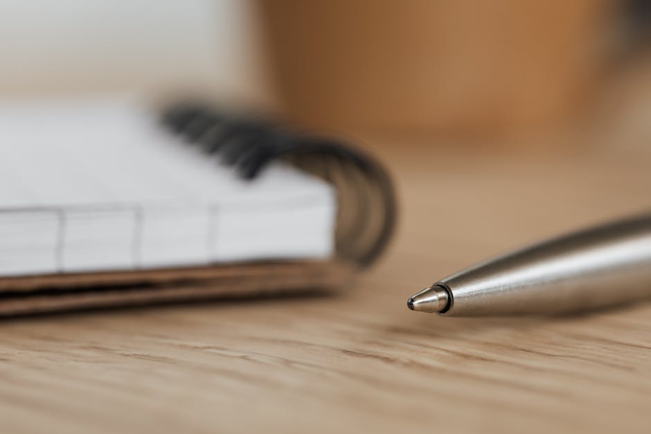 Person writing in a gratitude journal at a desk