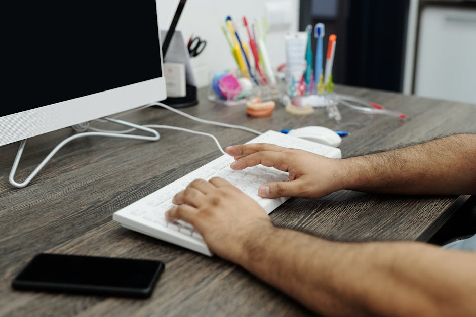 Person updating resume and LinkedIn profile on a desktop computer