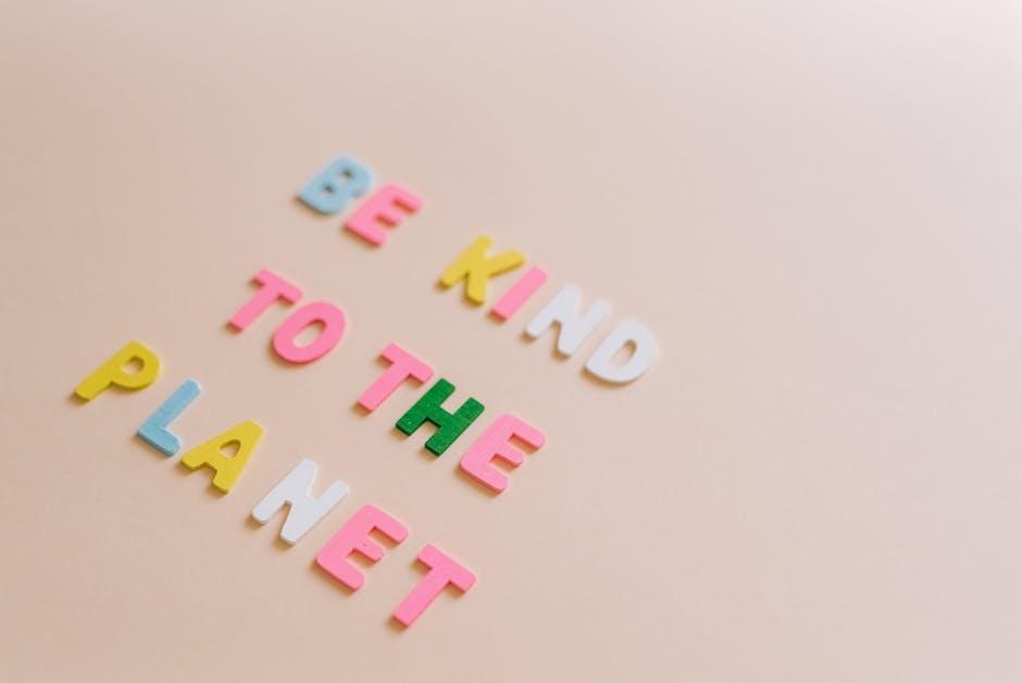 Lettres colorées sur fond beige formant "Soyez gentil avec la planète" pour sensibiliser au changement durable