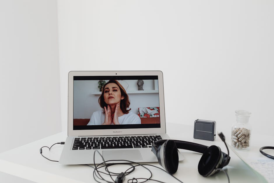 Person using laptop for telehealth therapy session at home