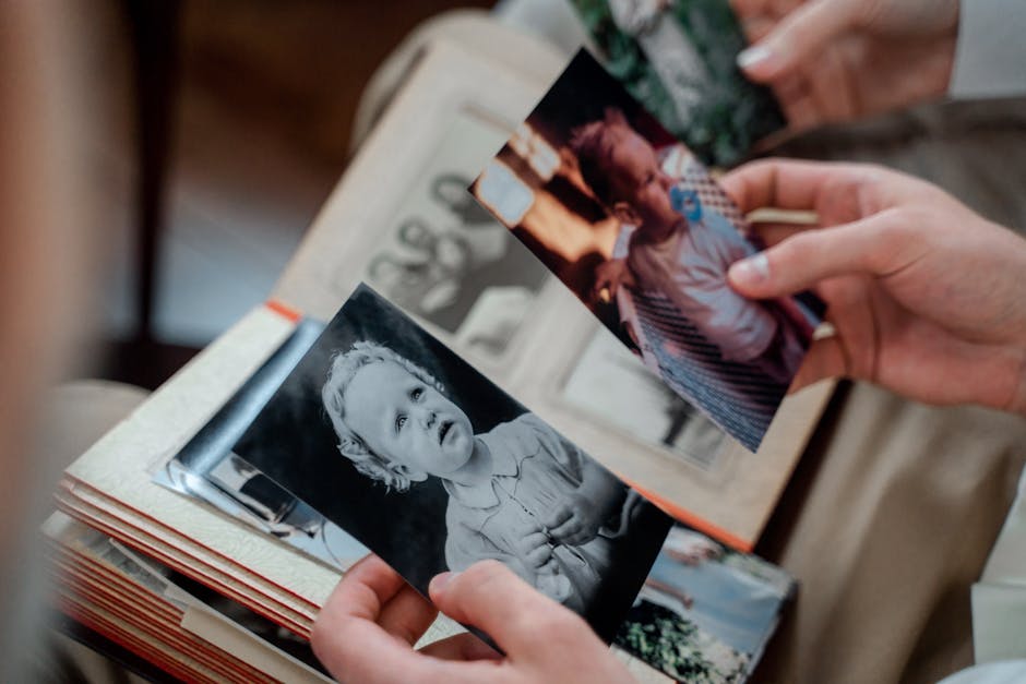 Person looking through old photo album with warm nostalgic mood
