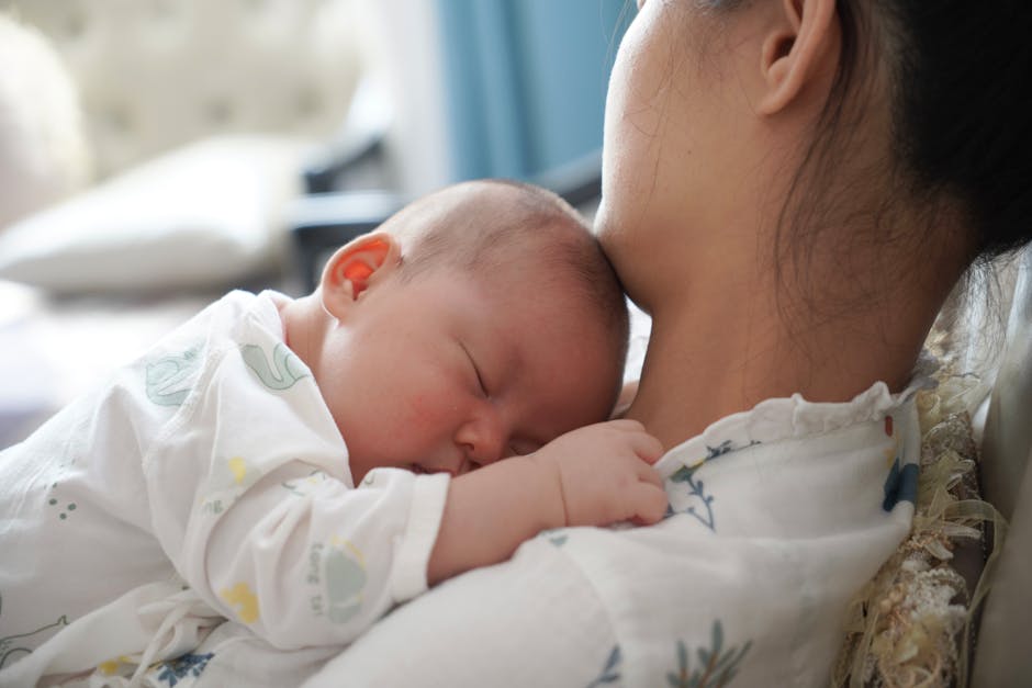 Parent holding a baby in a calm, intimate home setting