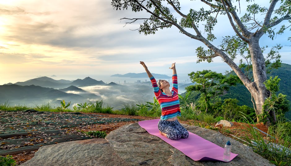 Person meditating outdoors at sunrise in a peaceful natural setting