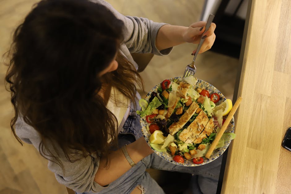 Person eating mindfully at a table, focused on food without distractions