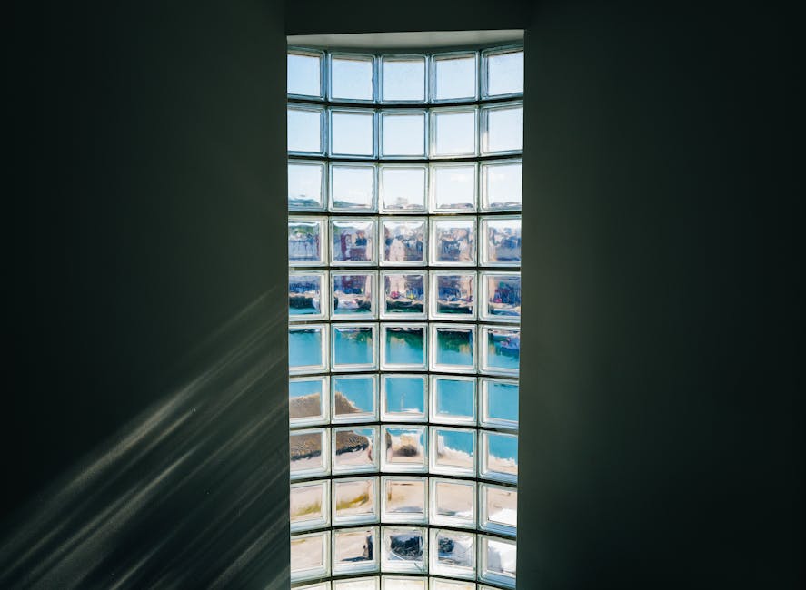A person looking out a window with a reflective posture, suggesting trauma and recovery
