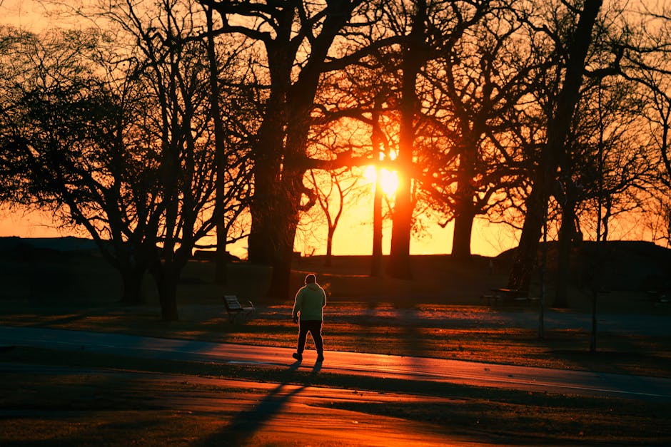 Person walking outdoors at sunrise with a sense of hope and reflection