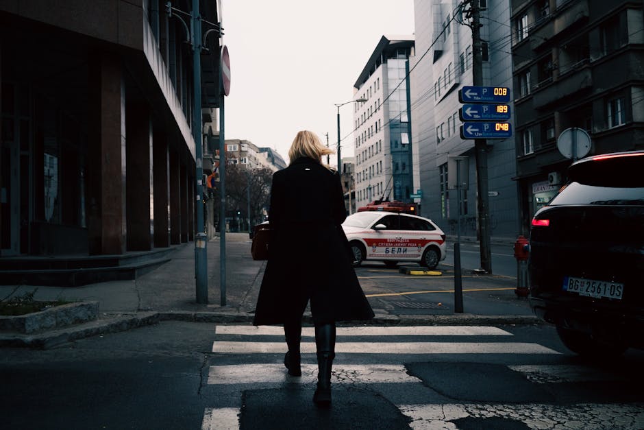 Urban mindful walker on a quiet city street with headphones off