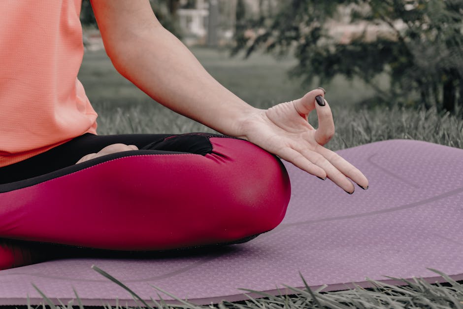 Person practicing diaphragmatic breathing on a yoga mat in a calm indoor setting