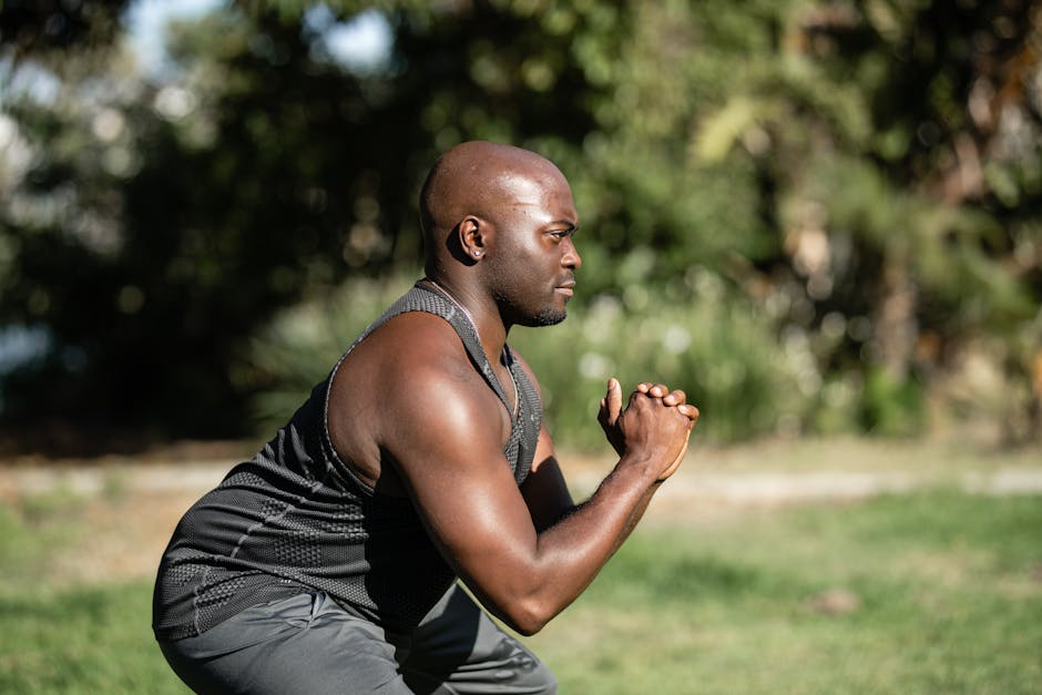 Athlete meditating before training on a sports field