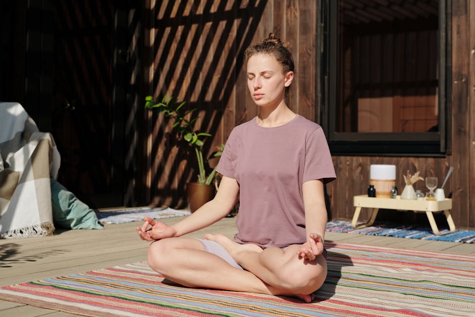Person meditating in a calm seated posture with soft natural light