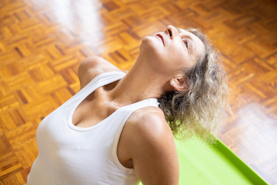 Mature woman doing breathing exercise at home in a comfortable chair