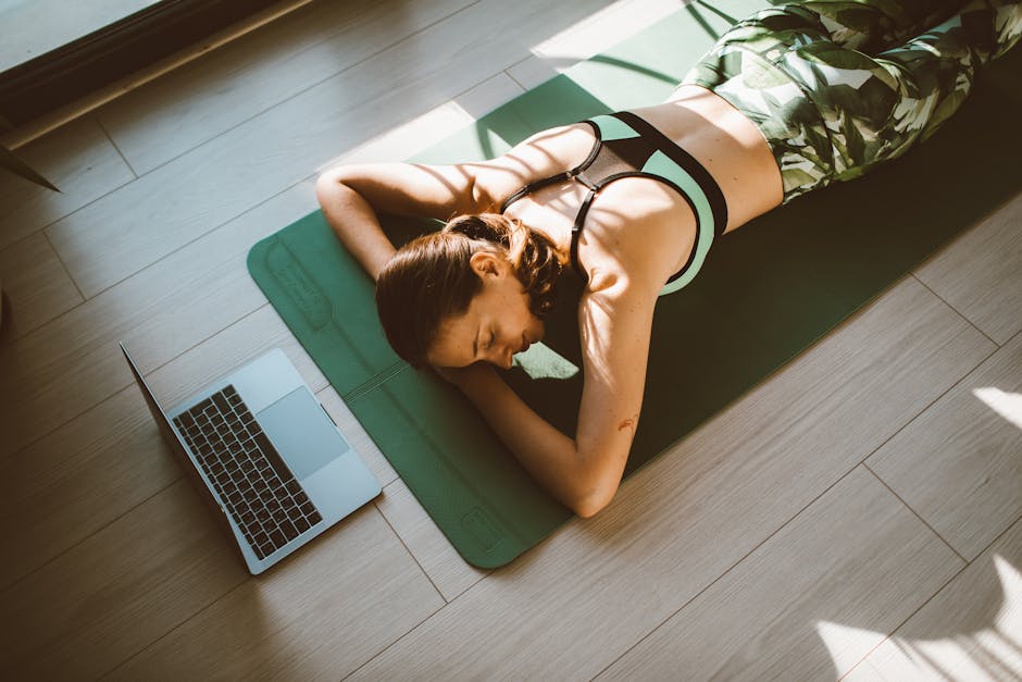 Person meditating lying on a yoga mat in a calm room