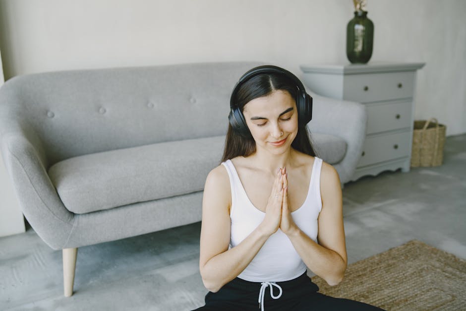 Person practicing guided meditation with headphones and phone