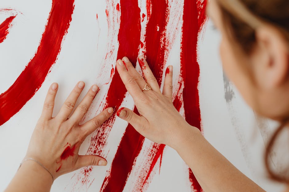 Person painting abstract artwork as a form of emotional expression