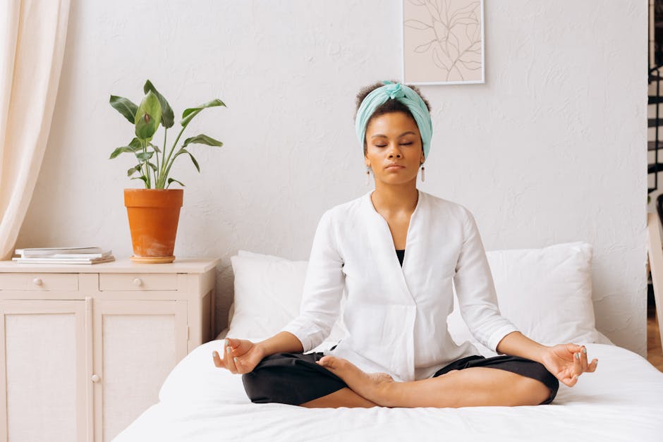 Person practicing deep breathing meditation in a calm bedroom