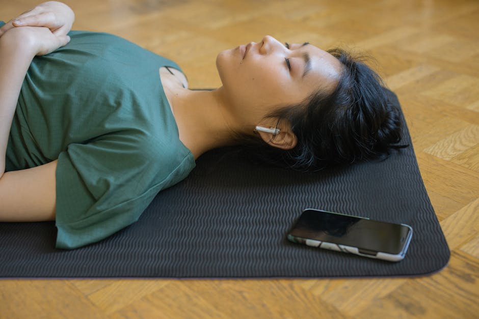 Person meditating with smartphone app in a calm indoor setting