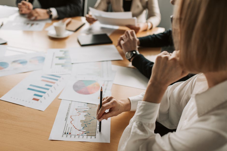 Leader analyzing team performance data in a meeting room