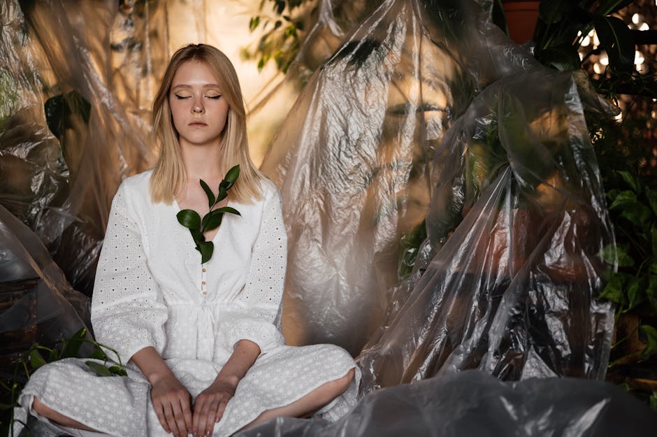 Person sitting quietly with eyes closed in a peaceful interior