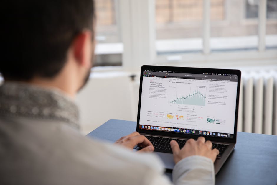 Focused professional working with charts and laptop