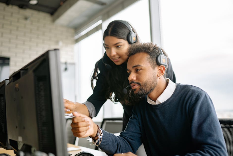 Person practicing kindness by helping a colleague in a modern office