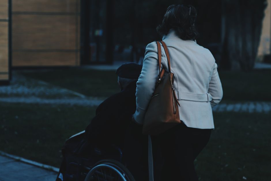 Supportive caregiver resting after helping a loved one, showing compassion fatigue and self-care