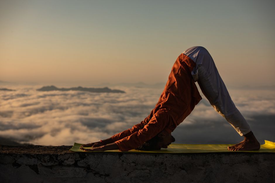 Person meditating in nature at sunrise