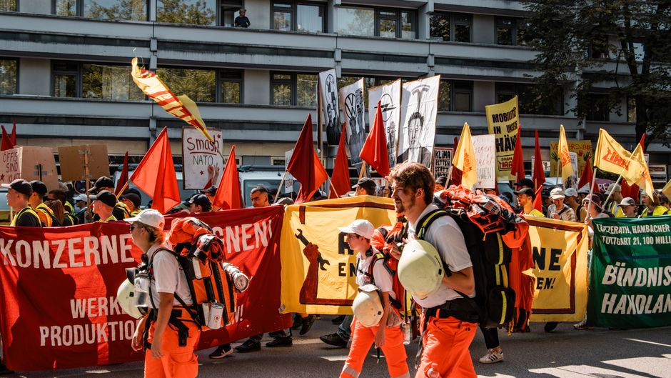 Climate protest with hands raised and banners, symbolizing collective action and resilience