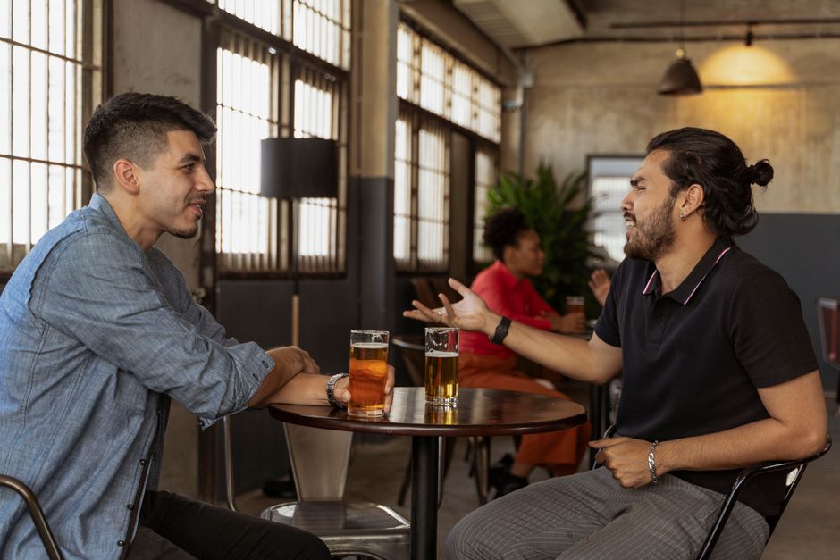 Adults sharing a warm conversation in a cozy café