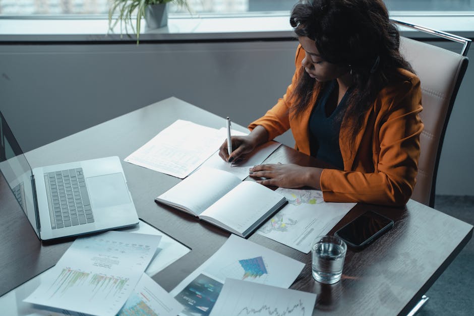 Person writing in notebook during self-reflection and career planning