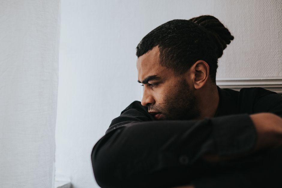 Person sitting by a window in quiet reflection