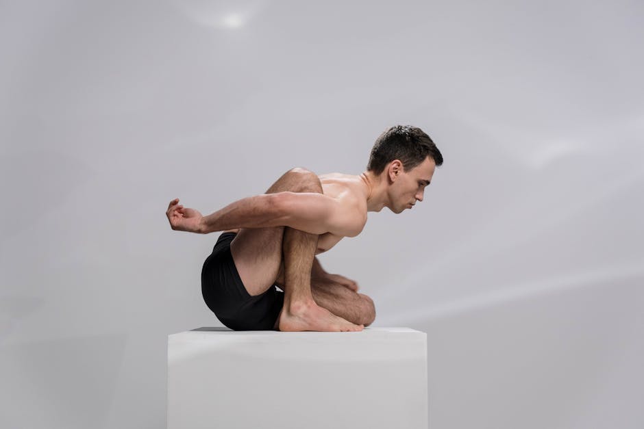 Yoga practitioner in a fluid movement sequence with soft light