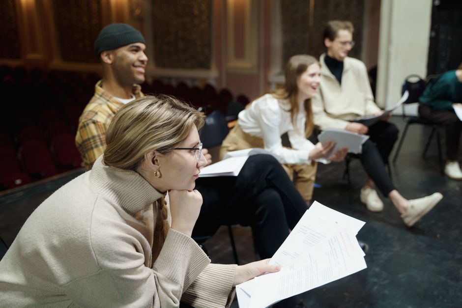 Diverse group in a theater workshop expressing emotions