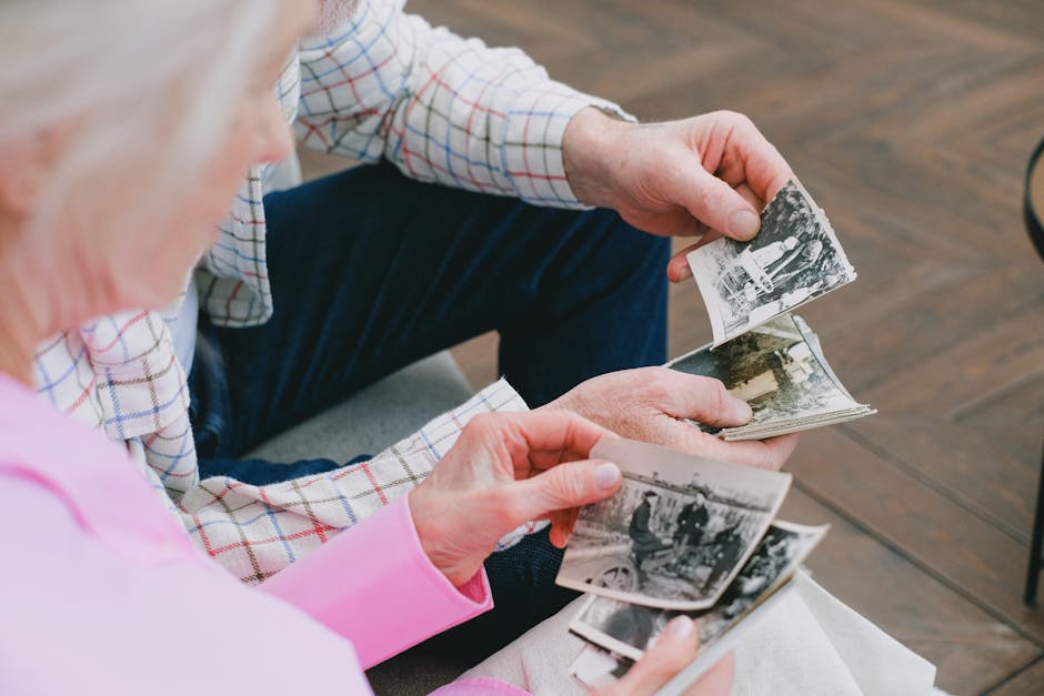 Family members looking at old photos and sharing memories at home
