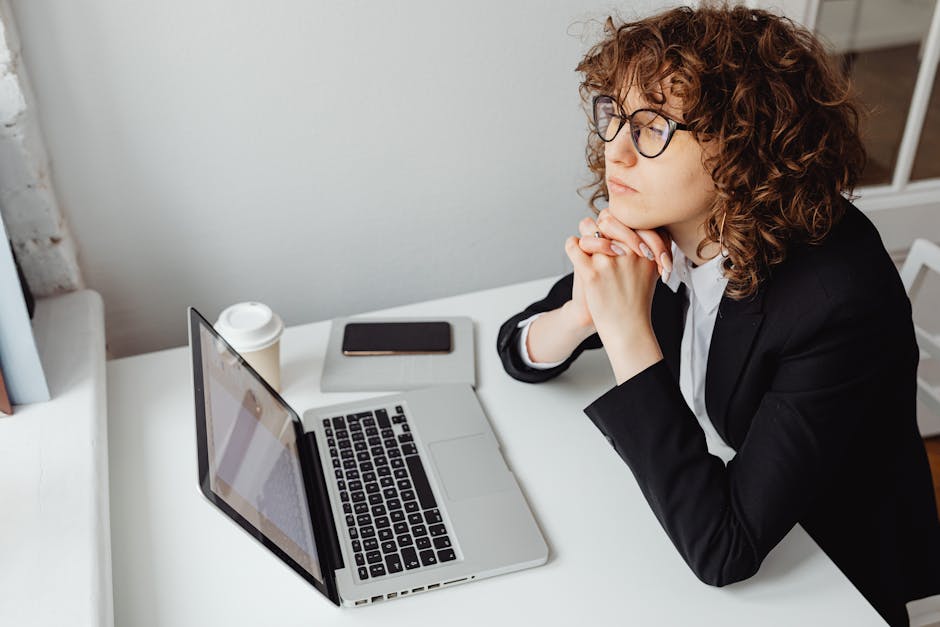 Professional woman reflecting on career purpose at a desk