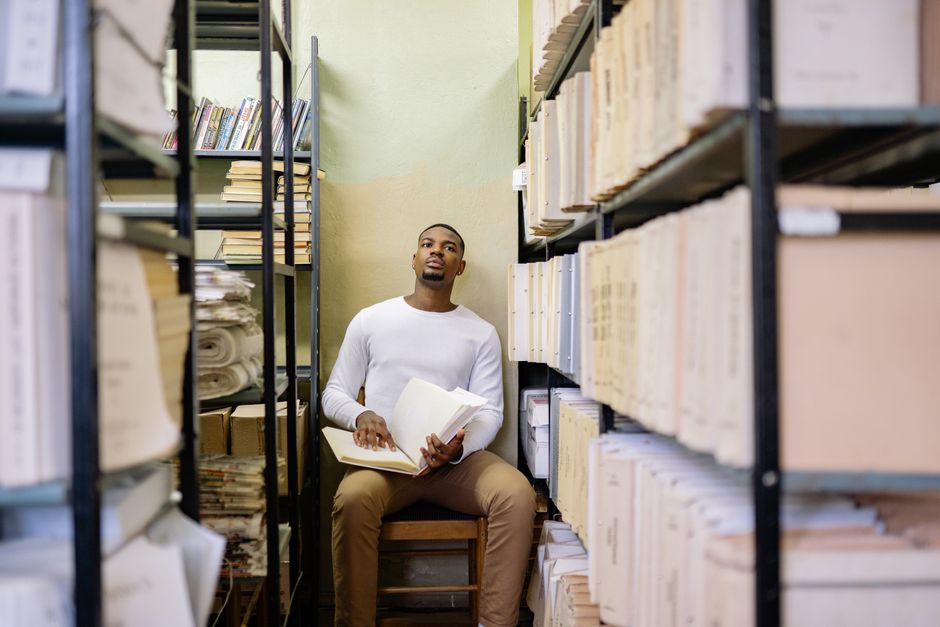 Researchers reviewing long-term study data in a Harvard archive room