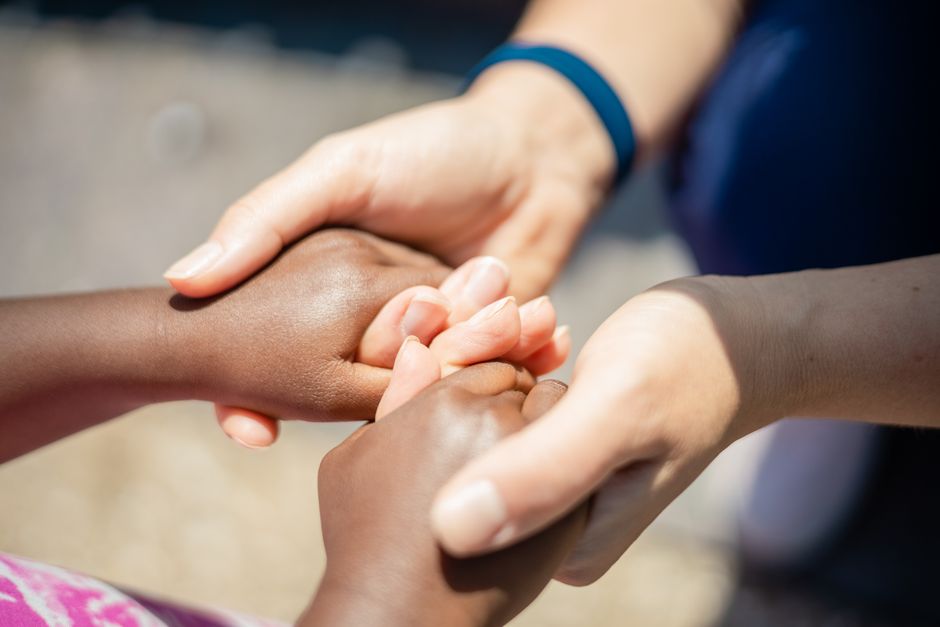 Hands supporting each other in a caring and supportive gesture
