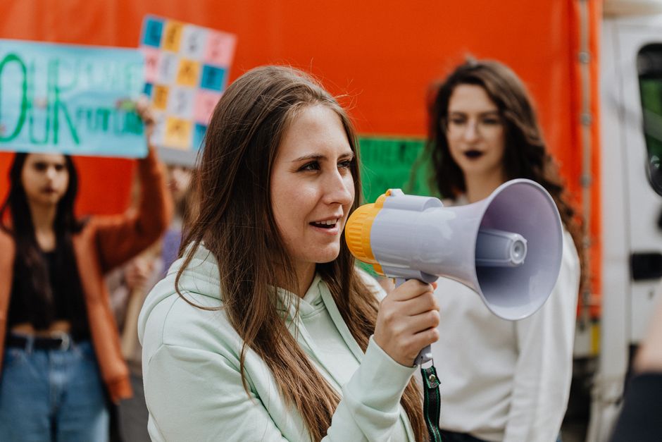 Young climate activists holding protest signs during a climate march