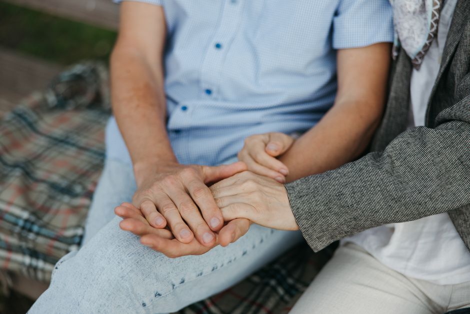 Two people holding hands on a date, symbolizing attachment and trust