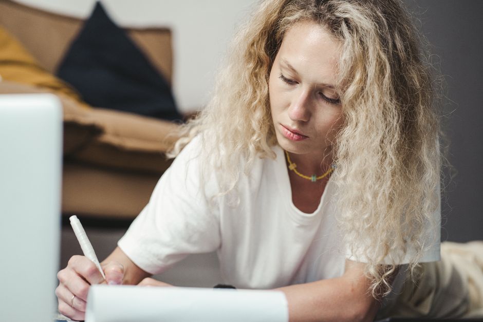 Person focused in deep work at a desk with laptop and notebook