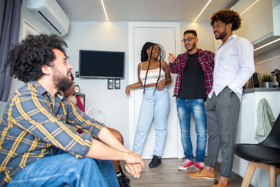A group of friends enjoying a relaxed conversation indoors in Portugal.